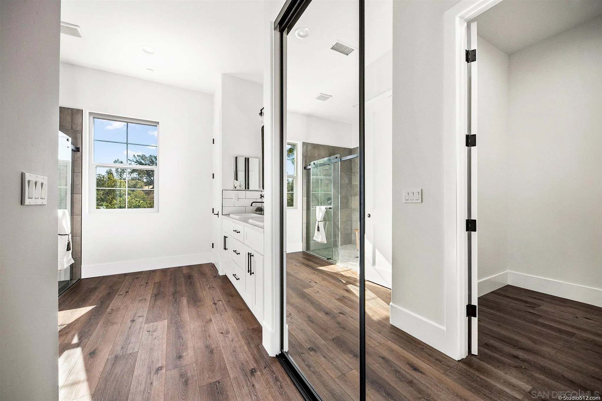 28661 Double K Road Valley Center, CA 92082 - Photo 20 of 34 a view of a hallway with wooden floor and a bathroom