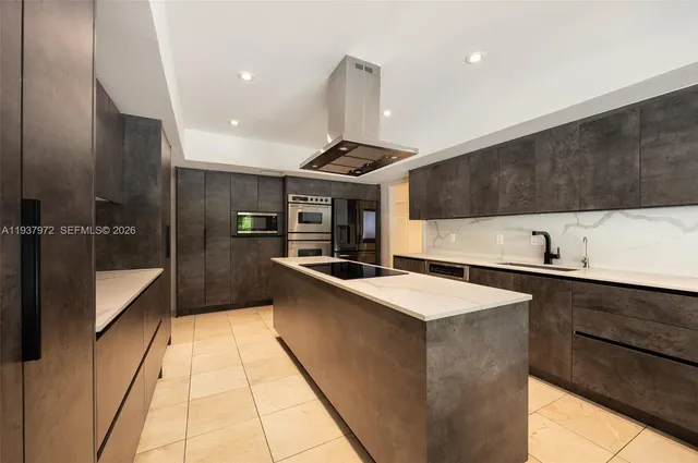 a kitchen with stainless steel appliances granite countertop a sink and a stove