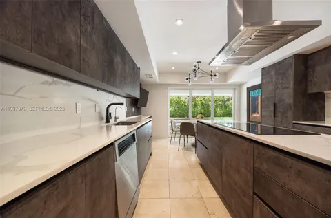 a kitchen with a sink and large windows