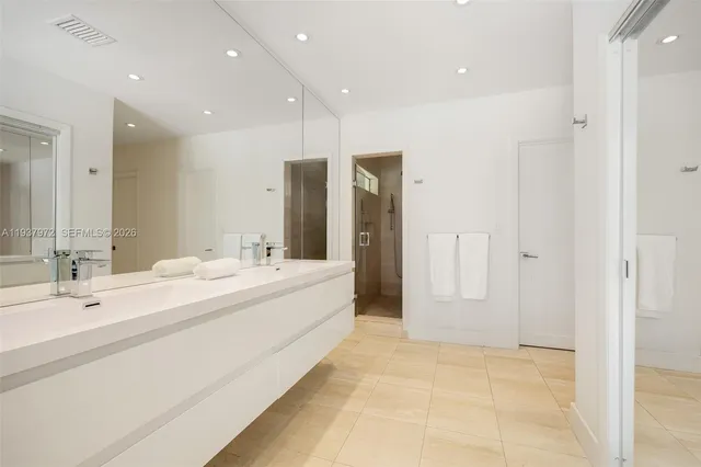 a bathroom with a double vanity sink mirror and double