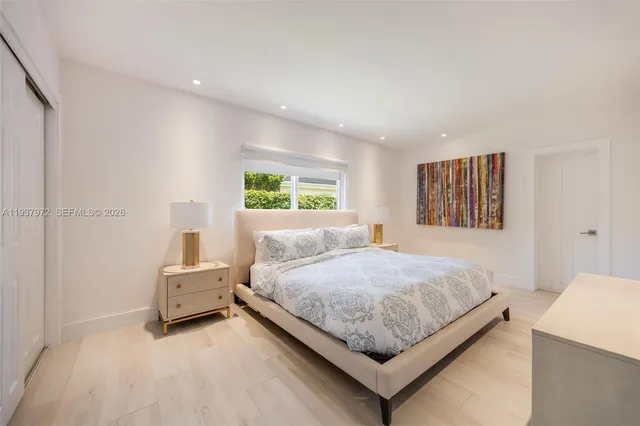 a bedroom with bed and window