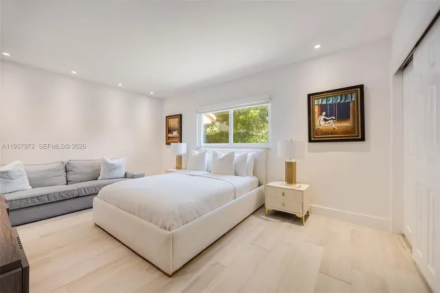 a bedroom with a bed and a couch