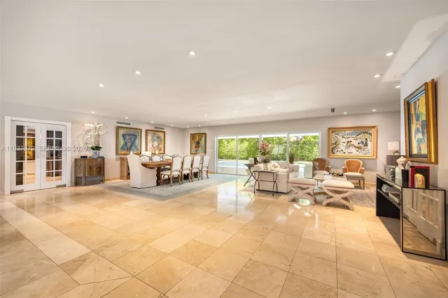 a living room with fireplace furniture and a large window
