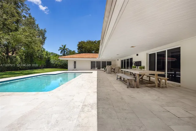 a view of a house with swimming pool and sitting area