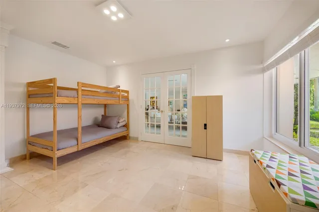 a bedroom with furniture and a window