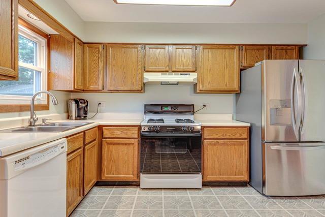 361 Cherry Valley Road Vernon Hills, IL 60061 - Photo 2 of 15 a kitchen with a refrigerator sink and cabinets