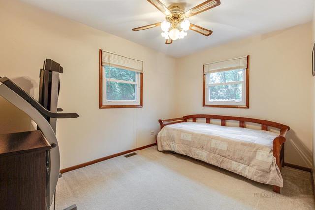 361 Cherry Valley Road Vernon Hills, IL 60061 - Photo 10 of 15 a bedroom with a bed and a chandelier