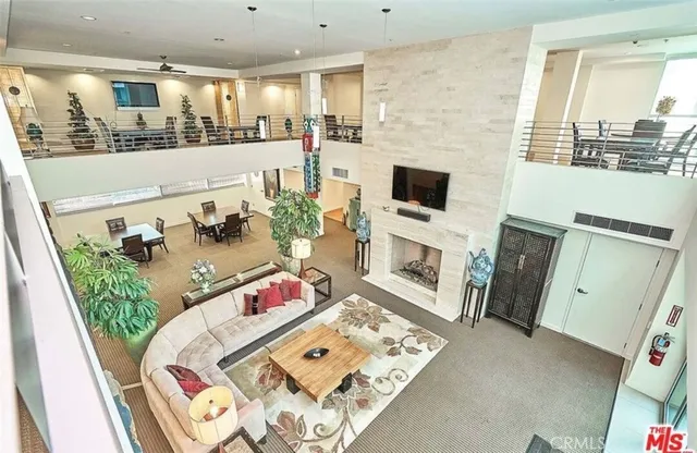 a dining room with stainless steel appliances kitchen island granite countertop a table and chairs