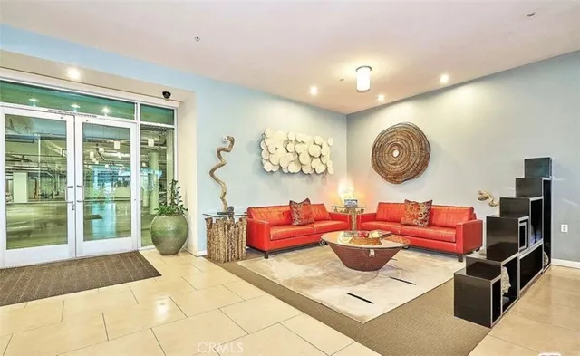 a lobby with furniture and potted plants