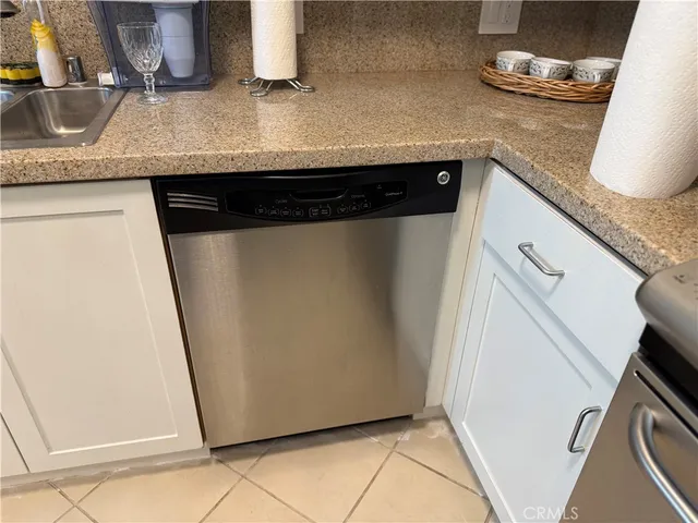 a kitchen with a sink and a refrigerator