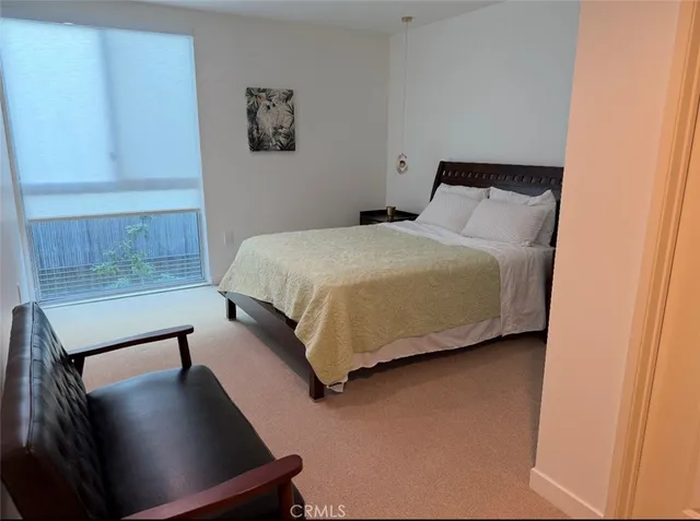 a bedroom with a bed and cabinet