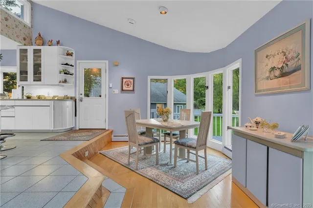 a view of a dining room with furniture and a potted plant