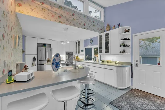 a kitchen with stainless steel appliances kitchen island granite countertop a sink and cabinets