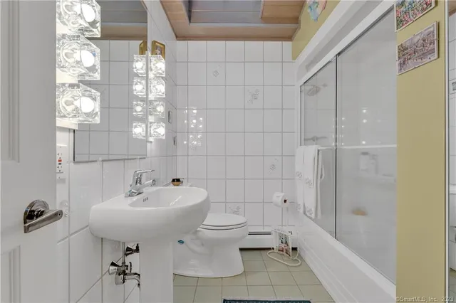 a bedroom with a large bed and a dresser