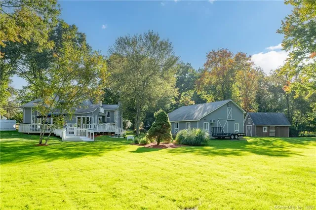 a view of a house with swimming pool and sitting area