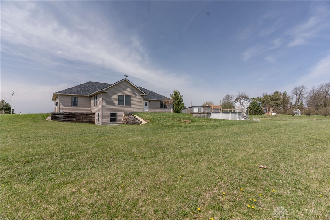 5264 Frazier-Guy Road Sidney, OH 45365 - Photo 47 of 51 This residence features a sloped lot and an inviting outdoor pool with a surrounding deck.
