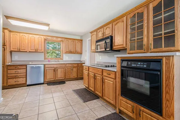 a kitchen with stainless steel appliances a stove sink and cabinets