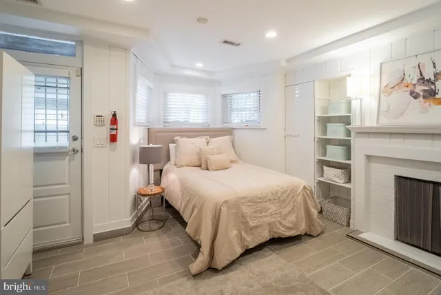 a bedroom with a bed and a fireplace