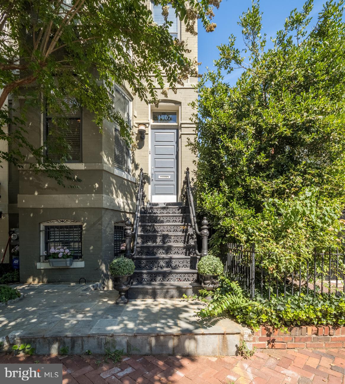 1407 33rd Street Northwest Washington, DC 20007 - Photo 2 of 17 a front view of a house with a garden