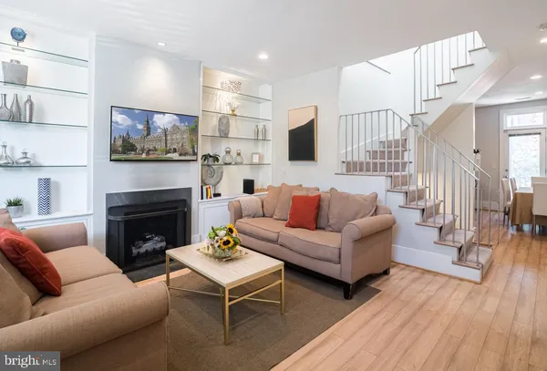 a living room with furniture a fireplace and a flat screen tv