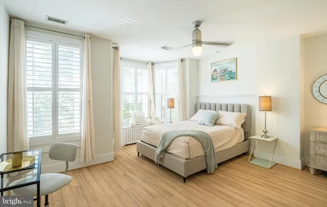 a bedroom with a bed and wooden floor