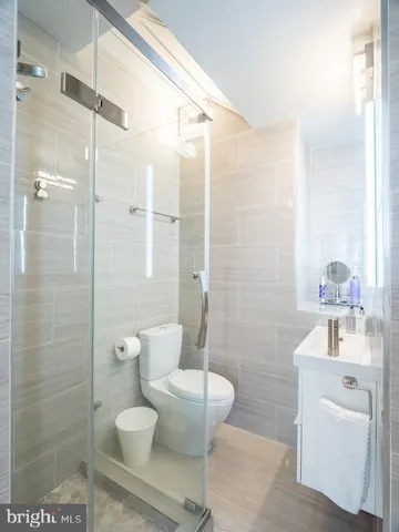 a bathroom with a toilet sink and shower