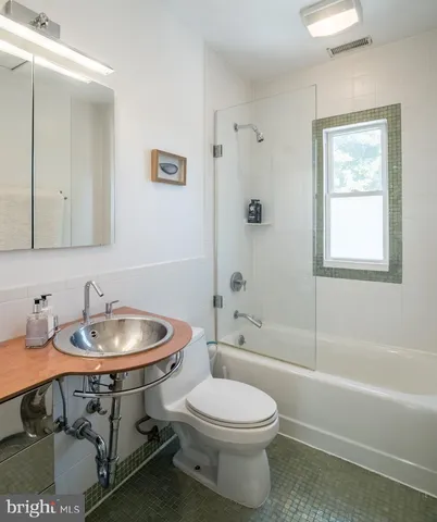 a bathroom with a sink a toilet and a bathtub