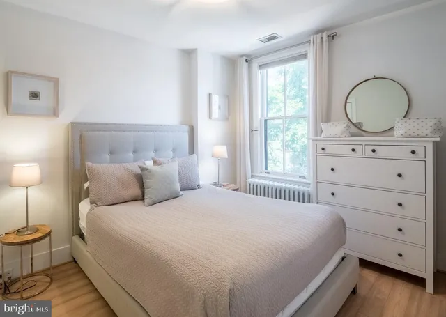 a bedroom with a bed and a dresser