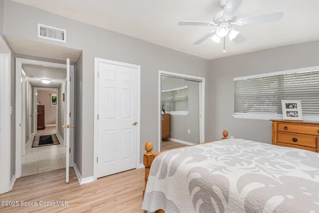 a bathroom with a toilet sink vanity and mirror