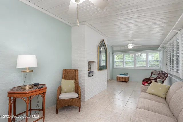 a view of a patio with table and chairs and wooden floor