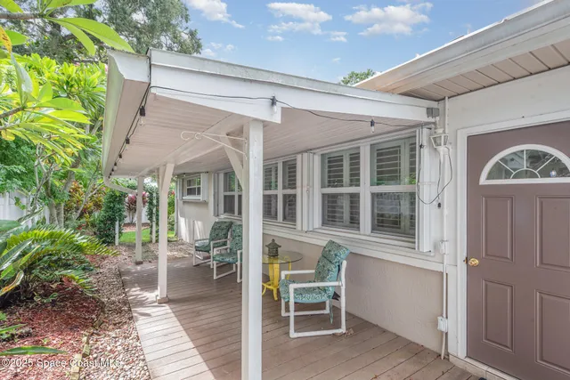 a backyard of a house with table and chairs