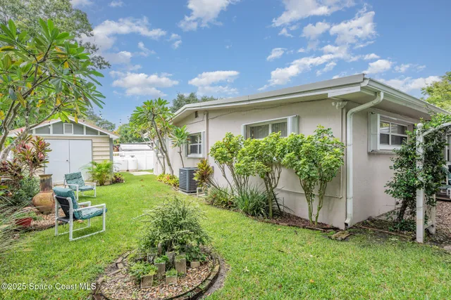 a wooden bench sitting in the middle of a garden