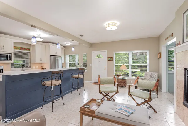 a kitchen with stainless steel appliances kitchen island granite countertop a refrigerator and a stove top oven