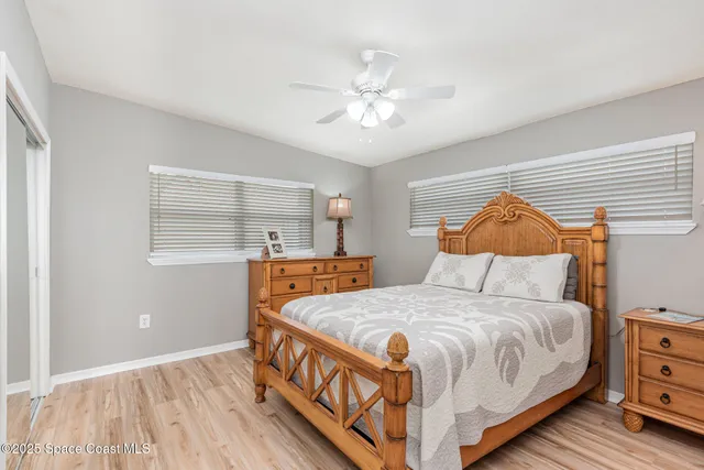 a bedroom with a large bed and chandelier
