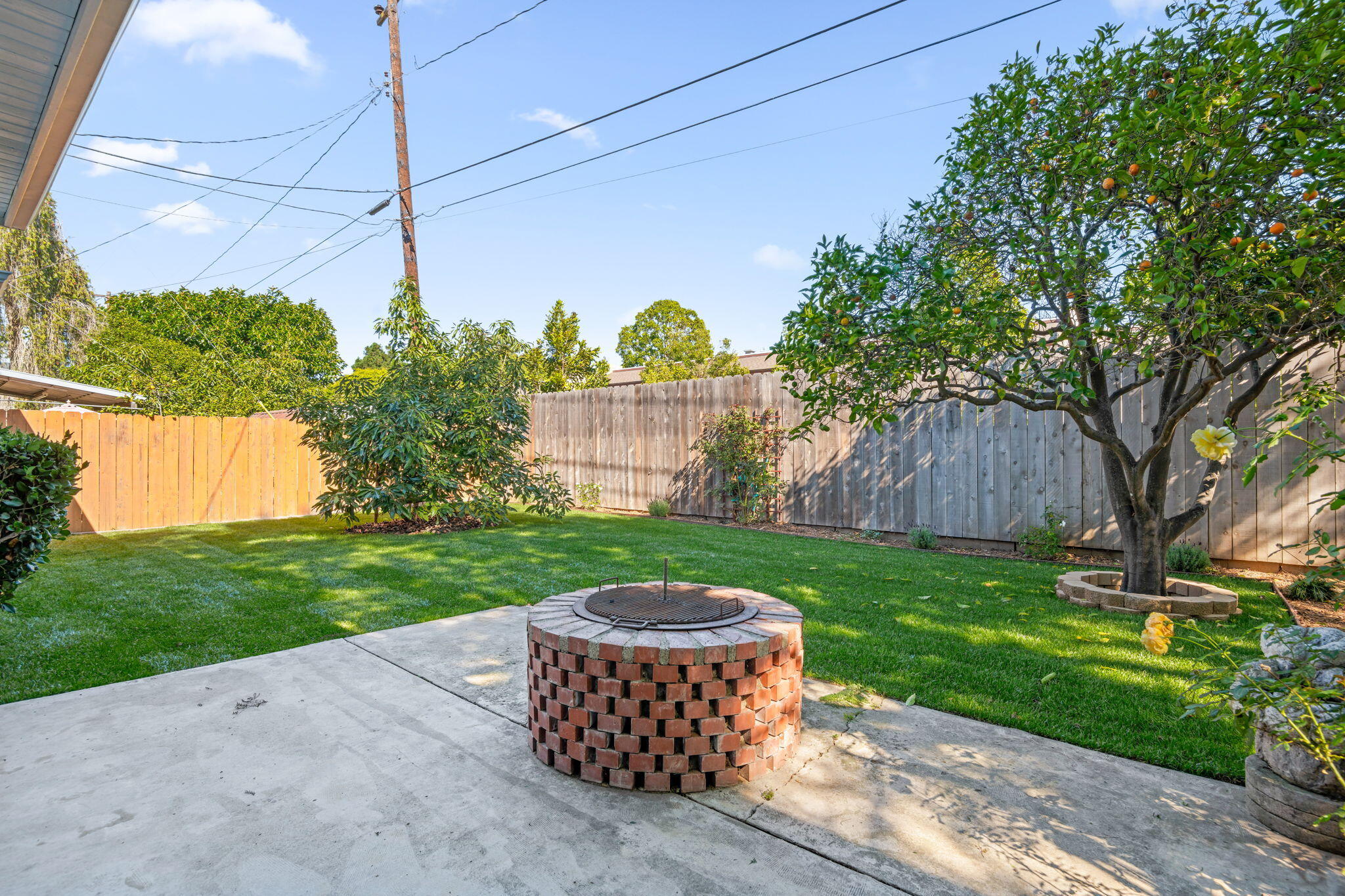 122 Kinman Avenue Goleta, CA 93117 - Photo 12 of 20 a view of a backyard with table and chairs potted plants and a palm tree