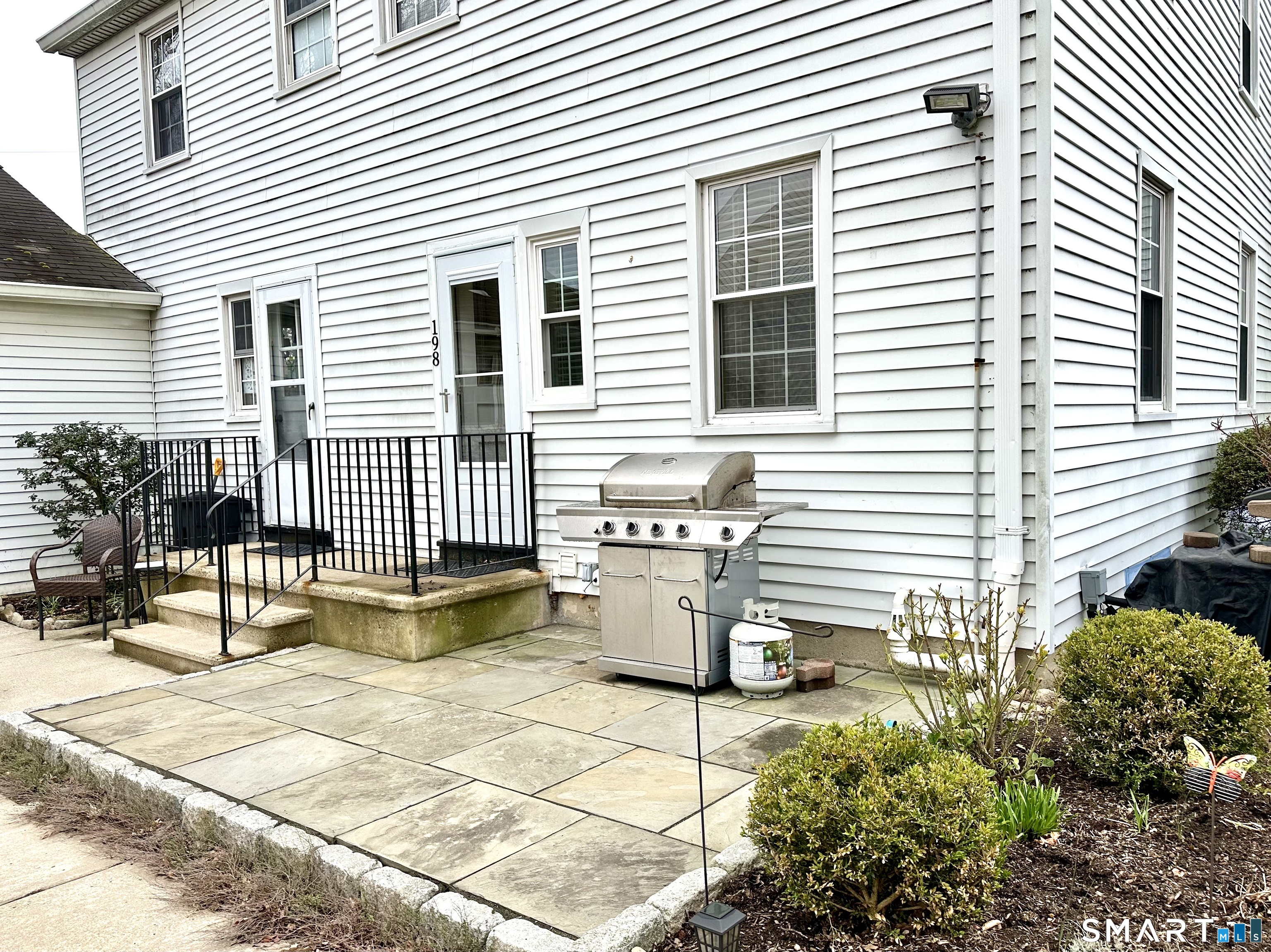 198 Sylvan Knoll Road Stamford, CT 06902 - Photo 12 of 17 a view of a patio with a table and chairs and potted plants