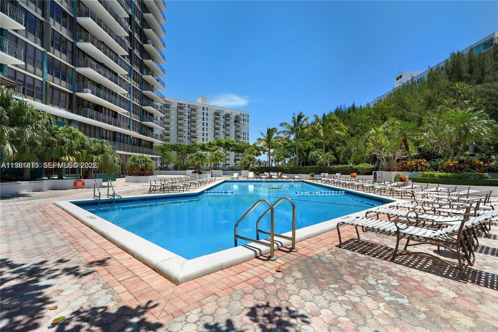 780 Northeast 69th Street, Unit 2201 Miami, FL 33138 - Photo 13 of 15 a view of a swimming pool with chairs