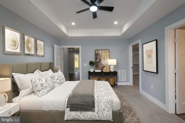 a kitchen with a center island wooden floor and stainless steel appliances
