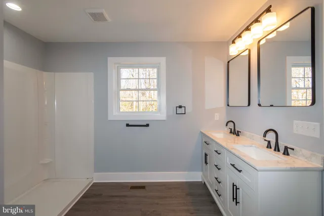 a view of an empty walk in closet and a window