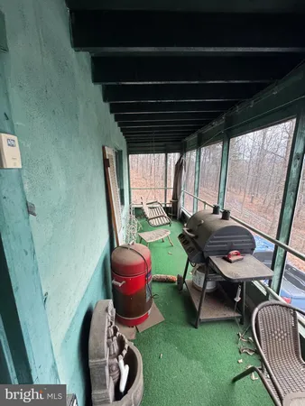 a view of porch with furniture and a window