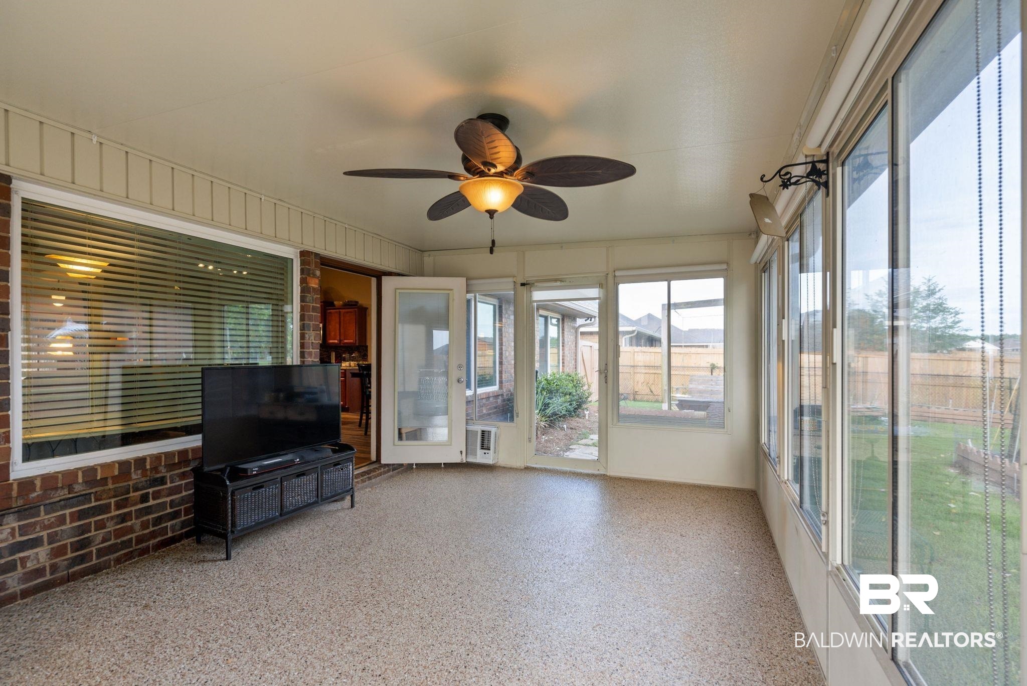 562 Vestige Mews Foley, AL 36535 - Photo 36 of 54 Screened-in porch featuring a ceiling fan with integrated lighting, extensive window panels, and double glass doors