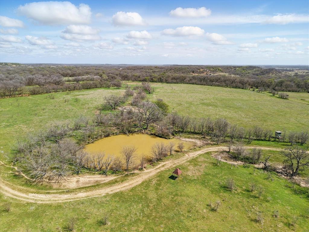 3141 Rogers Road Jacksboro, TX 76458 - Photo 36 of 40 Drone / aerial view with a view of pond and one of the pastures