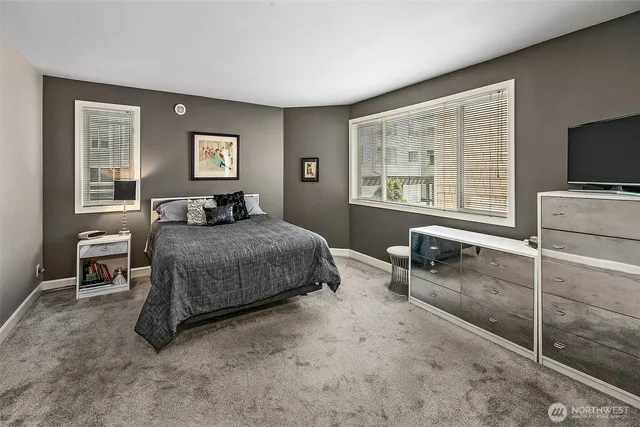 a view of a hallway with wooden floor and living room