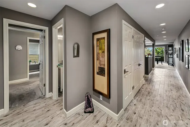 a large white kitchen with a large counter top appliances and cabinets