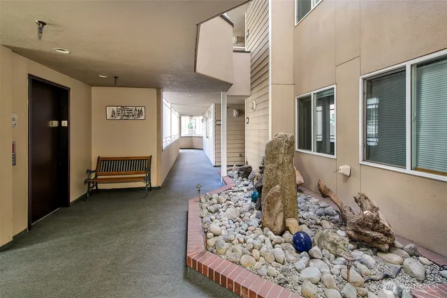 a front view of a house with garden and sitting area