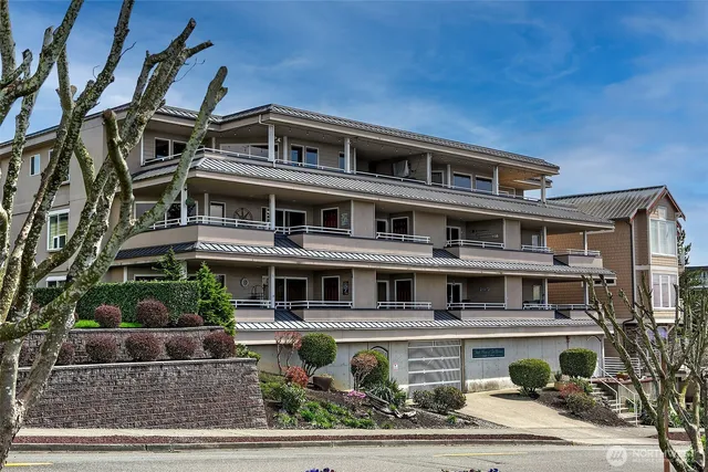 an aerial view of a house with a garden and lake view
