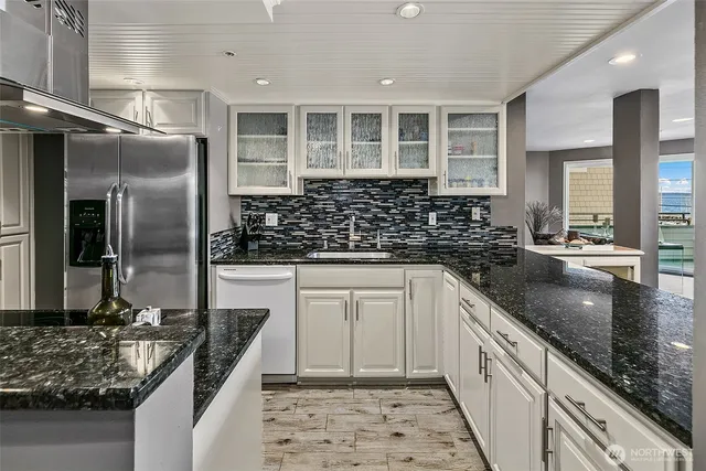 a kitchen with stainless steel appliances a sink and cabinets