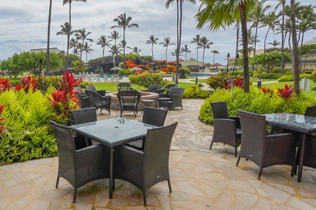 a view of a chairs and table in a backyard
