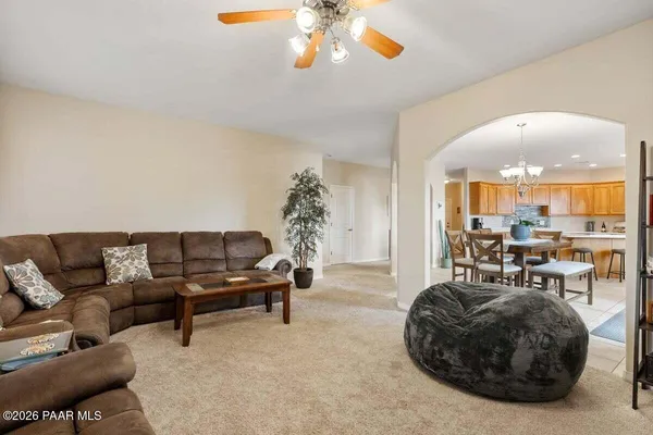 a view of a livingroom with furniture and a large window