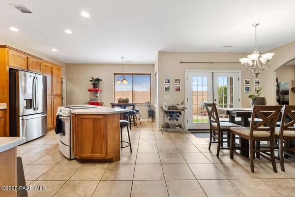 a view of a dining room with furniture and chandelier